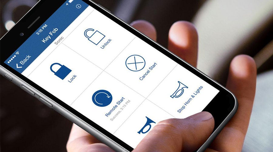 A hand using a smartphone app to remotely control car functions