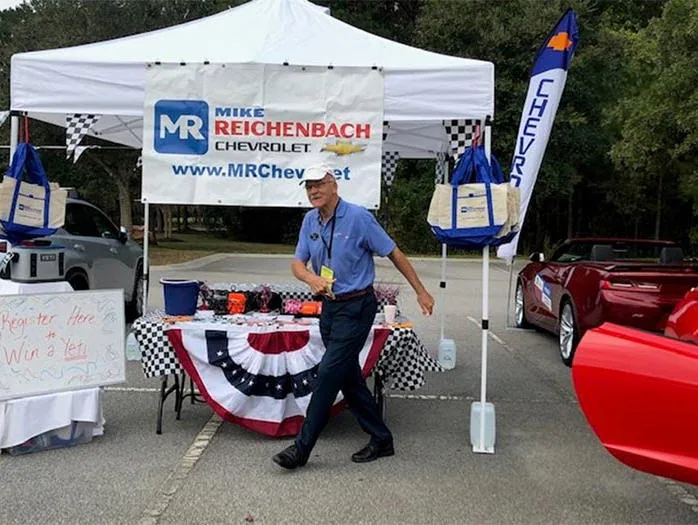 Man stands by a Mike Reichenbach Chevrolet event tent