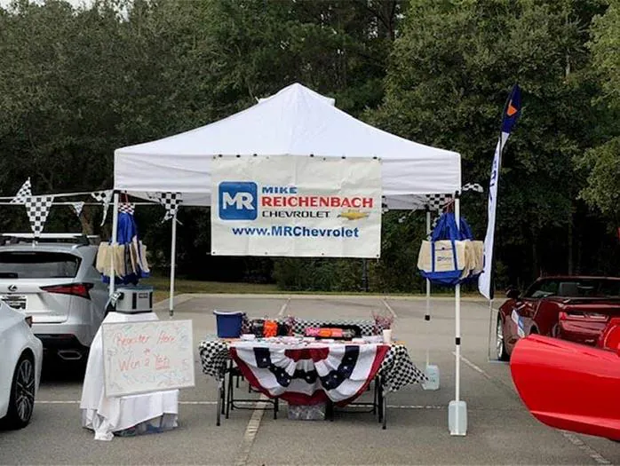 Mike Reichenbach Chevrolet dealership tent displaying merchandise outdoors